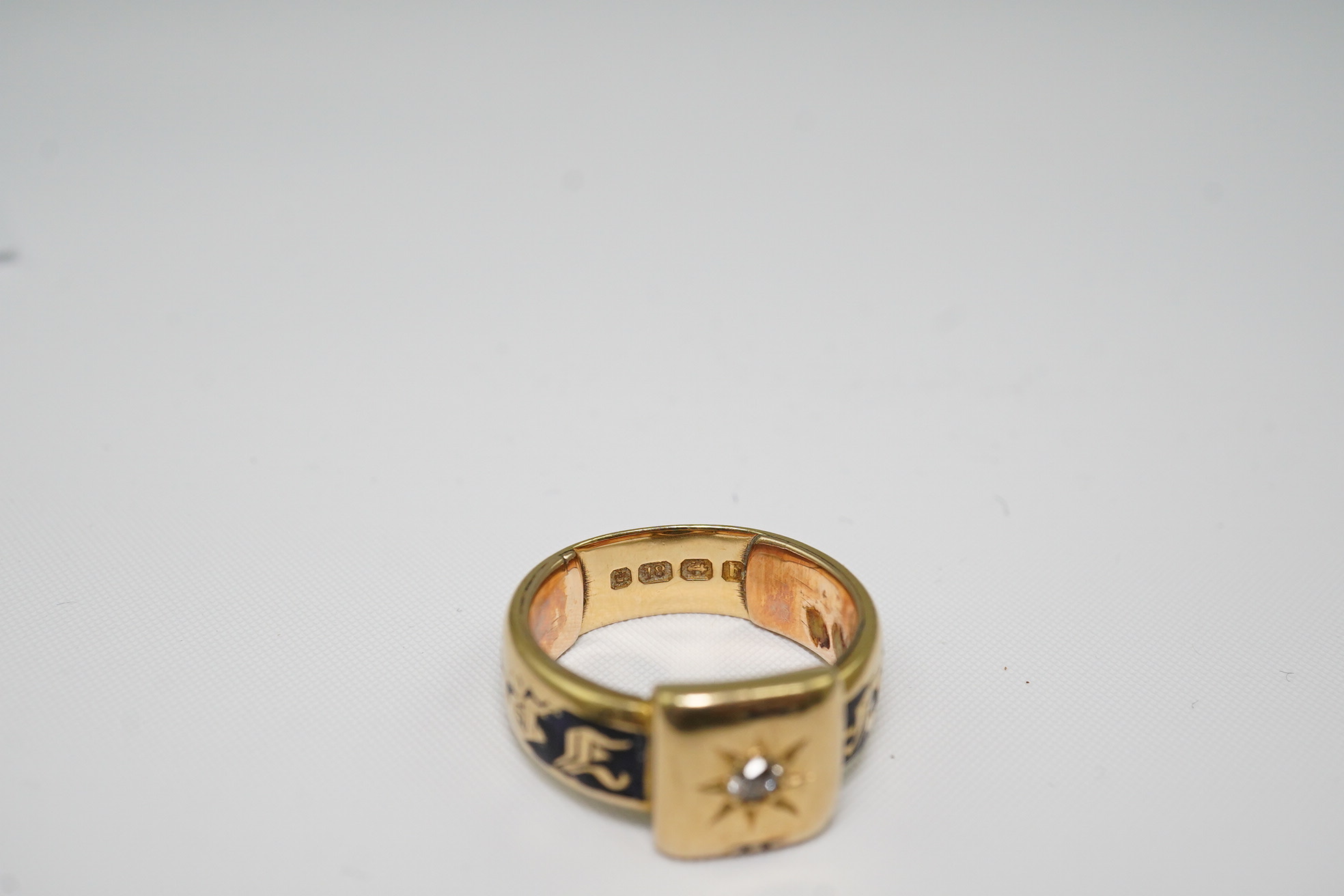 A 19th century 18ct gold, black enamel and single stone diamond set mourning ring